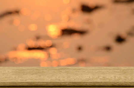Old wood shelf with sunset and bokeh background.