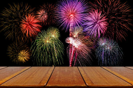 Firework celebration on dark background with Wood Table.の写真素材