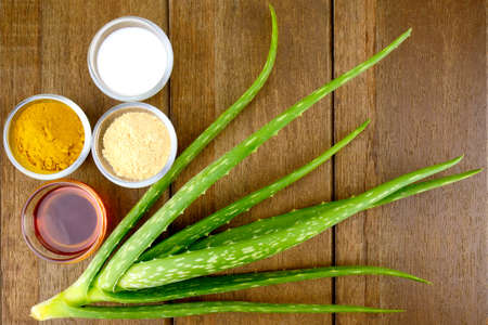 Facial Treatment Recipe with Fresh Aloe Vera on Wood Background.の写真素材