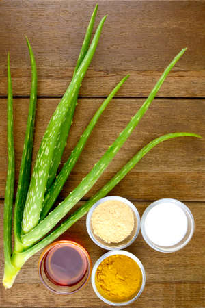 Facial Treatment Recipe with Fresh Aloe Vera on Wood Background.の写真素材