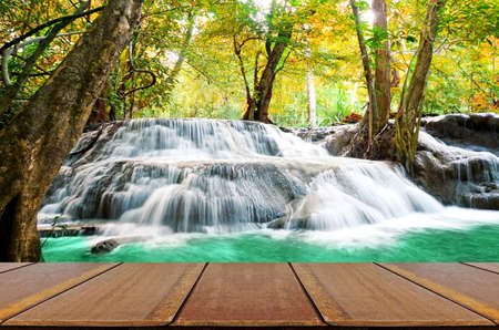 Perspective wood window view with beautiful scenic of waterfall in autumn forest.の写真素材