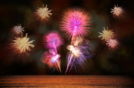 Firework celebration from the sea shore.の写真素材