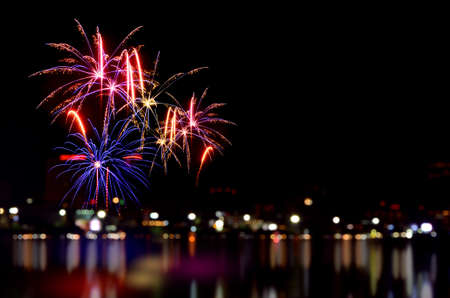 Colorful fireworks celebration and the city night light background.の写真素材