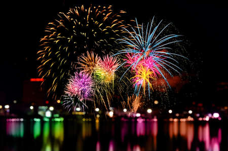 Colorful fireworks celebration and the city night light background.の写真素材