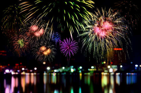 Colorful fireworks celebration and the city night light background.の写真素材