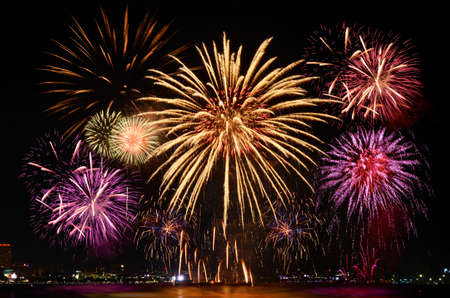 Colorful firework celebration from the sea shore.の写真素材