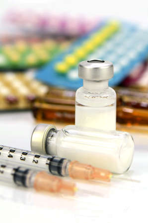 Injection medication with pills strips background.の写真素材