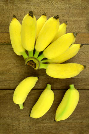 Cultivated Banana (Musa sapientum Linn.) on Natural Wood Background.の写真素材