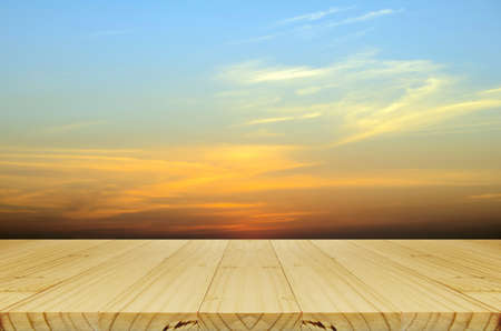 Picnic wood table and Blurred Sunrise Background, the Natural Lighting Phenomena.の写真素材