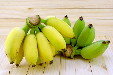 Cultivated Banana (Musa sapientum Linn.) on Natural Wood Background.の写真素材