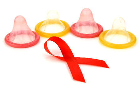 World Aids Day Red Ribbon Sign with Latex Condoms Background. For AIDS - HIV Prevention Campaign.の写真素材