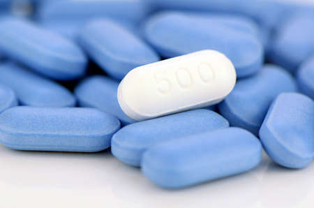 White caplet on blue caplets background.の写真素材
