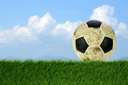 Shabby soccer ball on artificial turf field.の写真素材