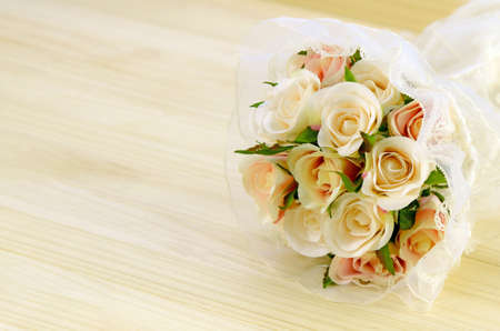 Satin Rose Bouquet on Pine Wood Background.の写真素材