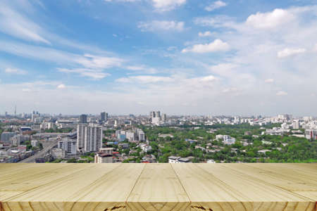 Window view with blurred cityscape and blue sky.
