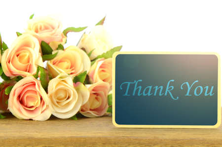 Wooden board signs on roses background with warm light tone.THANK YOU.の写真素材
