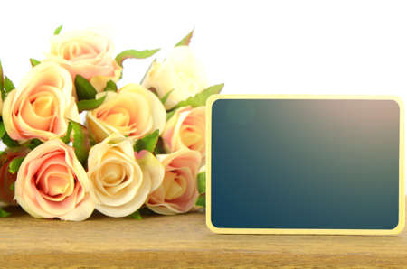 Wooden board signs on roses background with warm light tone.の写真素材