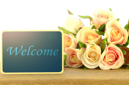 Wooden board signs on roses background with warm light tone. Welcome.の写真素材