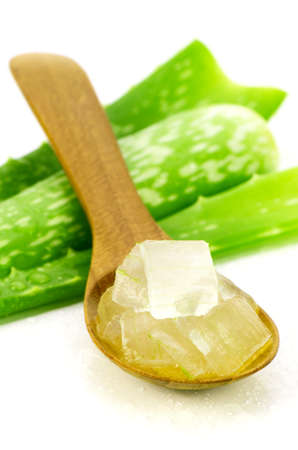 Aloe Vera Gel in Wooden Spoon with Aloe Vera Leaves on White Background. Aloe Vera gel almost use in food, medicine and beauty industry.の写真素材