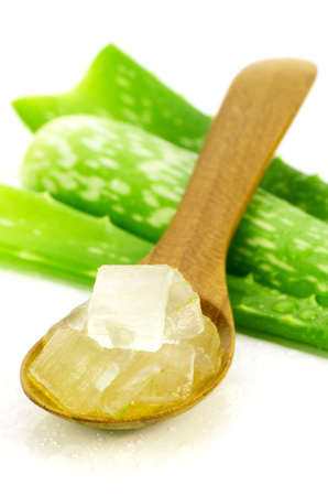 Aloe Vera Gel in Wooden Spoon with Aloe Vera Leaves on White Background. Aloe Vera gel almost use in food, medicine and beauty industry.のeditorial素材