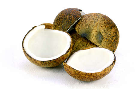 Coconut (Cocos nucifera). Cut coconut shell with fresh organic coconut kernel redy for make coconut milk and cold press coconut oli.の写真素材