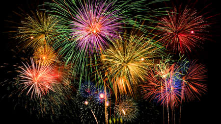 Colorful firework celebration on dark night sky background. Beautiful fireworks show on clear night sky.の写真素材