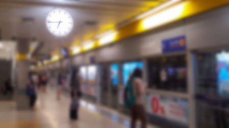 Blurred background of passenger at subway terminal.