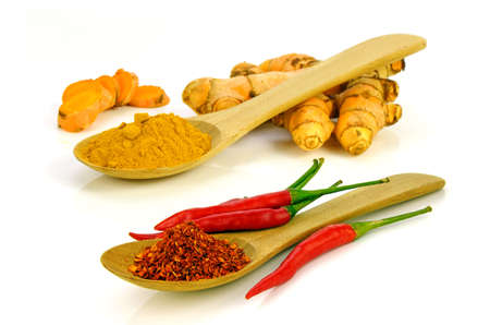 Turmeric (Curcuma longa L.) root powder and red hot pepper chilli (Capsicum frutescens L.) make hot and spicy ingredientsの写真素材