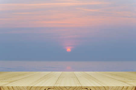 Perspectve Wood Table and Blurred Sunrise Background.の写真素材
