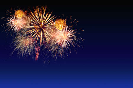 Colorful fireworks celebration and the city night light background.