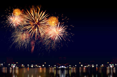 Colorful fireworks celebration and the city night light background.の写真素材