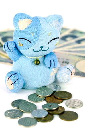 Maneki-neko, the lucky cat and Japanese money.の写真素材