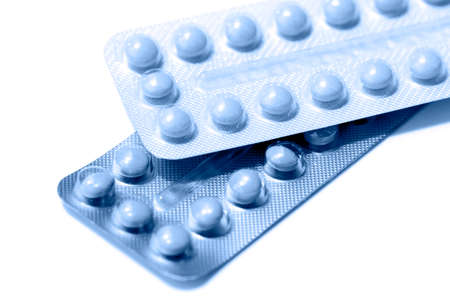 Pills strips in blue tone isolated on white background.の写真素材