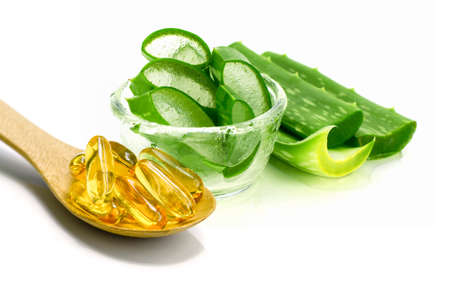 Vitamin E capsules and sliced Aloe Vera on white background.の写真素材