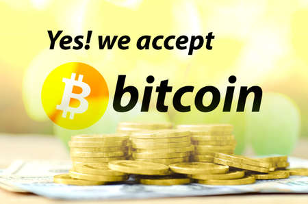 Bitcoin accepted sign with warm light tone and money background in cryptocurrency concept.の写真素材