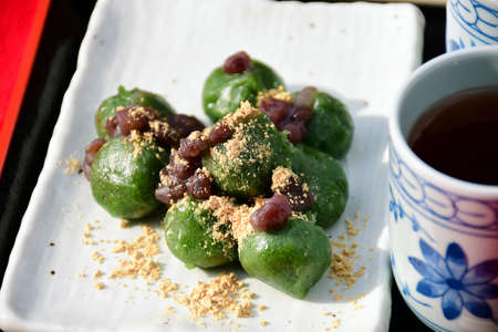Japanese Dango, Japanese Traditional Sweets. Dango green tea dumplings flavors topping with red bean paste (anko) served with hot tea.の写真素材
