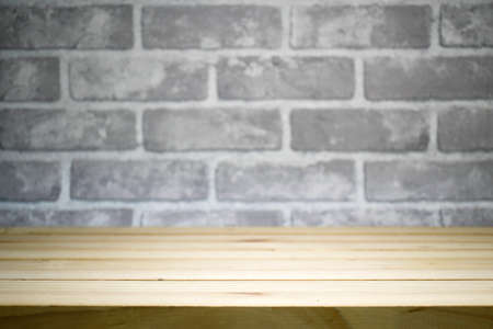 Bare cement wall in dark tone with pine wood table for  product display.の写真素材