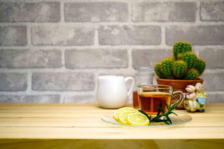 Red tea and lemon slice on pine wood table with copy space in teatime conceptの写真素材