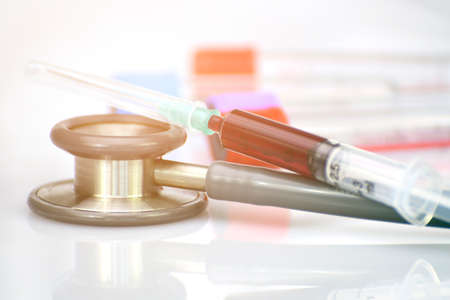 Stethoscope and blood in syringe in concept of health check up by blood dagnosis.の写真素材