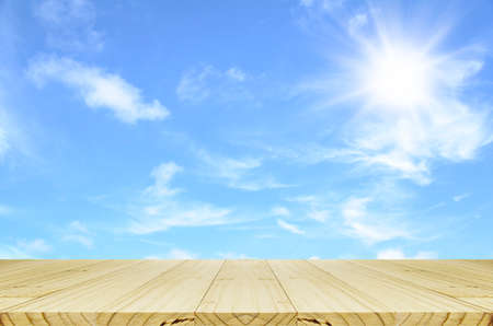 Empty wood table and outdoor picnic background concept in summer sun light.の写真素材