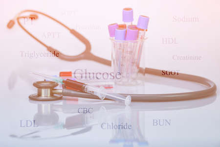 Stethoscope, blood in syringe and blood sampling tube in concept of health check up by blood...