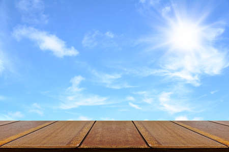 Empty wood table and outdoor picnic background concept in summer sun light.の写真素材