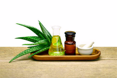 Aloe vera gel, essential oil and plant extract, the secret recipe for facial, skin and hair anti-aging therapy on wood tableの写真素材
