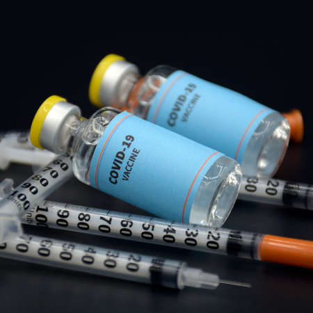 Two vials of sample of COVID-19 vaccine on black background. COVID-19 Vaccine or SARS-CoV-2 Vaccine is still in clinical trial phase in 2020.の写真素材