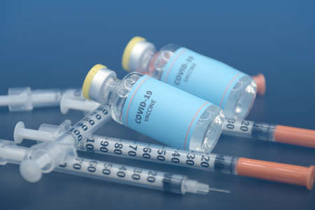 Two vials of sample of COVID-19 vaccine on black background. COVID-19 Vaccine or SARS-CoV-2 Vaccine...