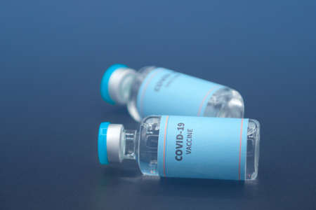 Two vials of sample of COVID-19 vaccine on black background. COVID-19 Vaccine or SARS-CoV-2 Vaccine is still in clinical trial phase in 2020.の写真素材