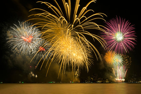 Colorful fireworks celebration and the city night light background with sea view.の写真素材