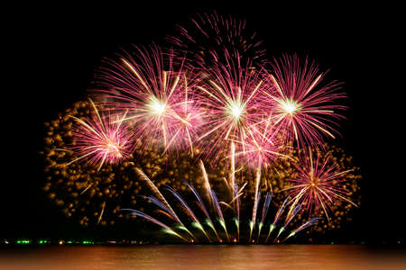 Firework celebration from the sea shore. Colorful fireworks celebration and the night sky background.の写真素材