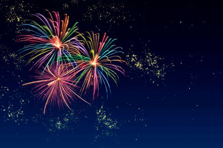 Colorful fireworks celebration and the twilight sky background with copyspace at the bottom of image.の写真素材