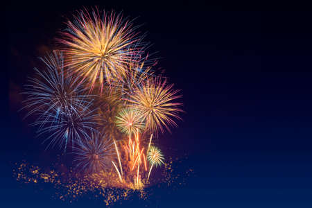 Colorful fireworks celebration and the twilight sky background with copyspace at the bottom of image.の写真素材